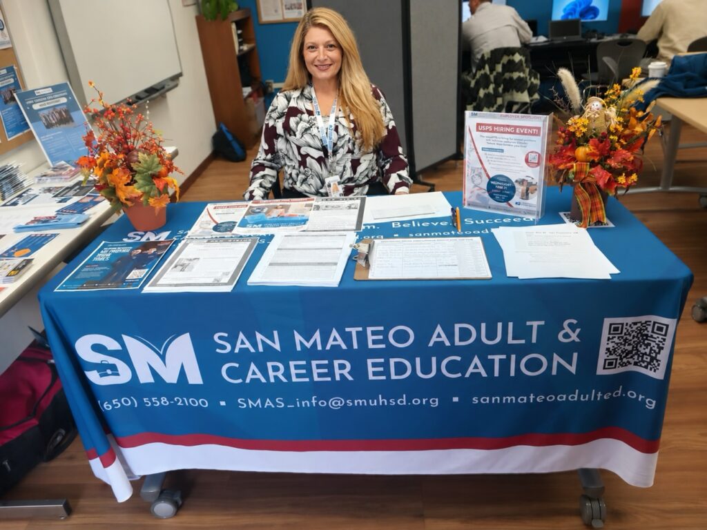San Mateo Adult & Career Education staffing a branded info table at a campus event
